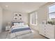 Bright bedroom featuring a plush bed, decorative artwork, and a sunlit window, creating a cozy and inviting atmosphere at 6882 Huddersfield Ln, Castle Pines, CO 80108