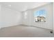 Bright bedroom features neutral carpet, two windows, and light walls at 6882 Huddersfield Ln, Castle Pines, CO 80108