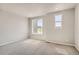 Sunlit bedroom with neutral carpet and two windows, offering a cozy and inviting space at 6882 Huddersfield Ln, Castle Pines, CO 80108