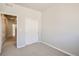 A bedroom with gray carpet, a double-door closet, and gray walls is move-in ready at 6882 Huddersfield Ln, Castle Pines, CO 80108