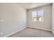 Bedroom featuring neutral gray walls, carpet, and a large bright window at 6882 Huddersfield Ln, Castle Pines, CO 80108