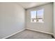 This bedroom features neutral gray walls and carpet, offering a calm and serene living space at 6882 Huddersfield Ln, Castle Pines, CO 80108