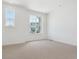 Bright bedroom with neutral carpet, white walls, and two windows offering neighborhood views at 6882 Huddersfield Ln, Castle Pines, CO 80108