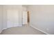 A bedroom with gray carpet, a double-door closet, and gray walls is move-in ready at 6882 Huddersfield Ln, Castle Pines, CO 80108