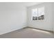 Bright bedroom features a large window and neutral carpet at 6882 Huddersfield Ln, Castle Pines, CO 80108