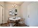 The dining room features modern furnishings and a contemporary chandelier, blending style and comfort at 6882 Huddersfield Ln, Castle Pines, CO 80108