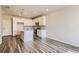 Modern kitchen features white cabinets, stainless steel appliances, gray backsplash, and an island at 6882 Huddersfield Ln, Castle Pines, CO 80108