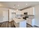 Modern kitchen features white cabinets, stainless steel appliances, granite countertops, and an island at 6882 Huddersfield Ln, Castle Pines, CO 80108
