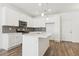 Contemporary kitchen with white cabinets, gray backsplash, stainless steel appliances, and a center island at 6882 Huddersfield Ln, Castle Pines, CO 80108