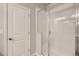 A pristine shower with a glass door and white tiled walls at 6882 Huddersfield Ln, Castle Pines, CO 80108