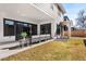 Relaxing outdoor living space, featuring stylish seating and access to the backyard and sliding door at 2255 S Monroe St, Denver, CO 80210
