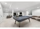 This finished basement features a recreational area with sleek furniture and a modern design at 2255 S Monroe St, Denver, CO 80210
