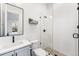 Modern bathroom with glass enclosed shower, black fixtures, and floating shelves at 2255 S Monroe St, Denver, CO 80210