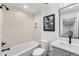 Bright bathroom featuring stylish horizontal tiling, sleek fixtures, and recessed shower niche at 2255 S Monroe St, Denver, CO 80210