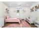 Charming bedroom features pink decor, hardwood floors, and a stylish chandelier at 2255 S Monroe St, Denver, CO 80210