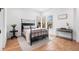 Bright bedroom with large windows, hardwood floors, and stylish wrought iron bed at 2255 S Monroe St, Denver, CO 80210