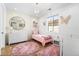 Charming bedroom features pink decor, hardwood floors, and a stylish chandelier at 2255 S Monroe St, Denver, CO 80210