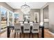 Elegant dining room with a crystal chandelier, large windows, and a dark wood table with seating for six at 2255 S Monroe St, Denver, CO 80210