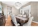 Refined dining area featuring elegant chandelier, plush seating, and seamless access to the hallway and staircase at 2255 S Monroe St, Denver, CO 80210