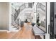 Spacious foyer boasts a staircase with iron railing, wood floors, and a bench with a view to the rest of the home at 2255 S Monroe St, Denver, CO 80210