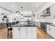 Contemporary kitchen featuring sleek cabinets, stainless appliances, and an island with barstool seating at 2255 S Monroe St, Denver, CO 80210