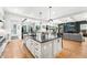 Bright, spacious kitchen with modern island, pendant lights, and stainless steel appliances at 2255 S Monroe St, Denver, CO 80210