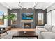 Living room featuring a fireplace with gray textured accent wall and floating mantle, flat screen tv, and neutral decor at 2255 S Monroe St, Denver, CO 80210