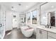 Bright bathroom with double vanities, freestanding tub, and modern fixtures at 2255 S Monroe St, Denver, CO 80210