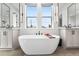 Bright bathroom with double vanities, freestanding tub, and modern fixtures at 2255 S Monroe St, Denver, CO 80210