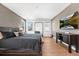 Main bedroom features a dark wood bed frame, textured walls, and a large mirror to expand the space at 2255 S Monroe St, Denver, CO 80210