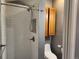 Clean bathroom with tiled shower and wood cabinet at 985 Xavier St, Denver, CO 80204