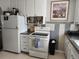 Galley kitchen with white cabinets and ample counter space at 985 Xavier St, Denver, CO 80204