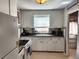 Efficient kitchen with white cabinets and an electric stove at 985 Xavier St, Denver, CO 80204