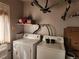 A functional laundry room, complete with washer and dryer, and shelving for storage at 985 Xavier St, Denver, CO 80204