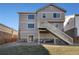 Beautifully landscaped backyard with a deck featuring stairs leading to the grassy yard at 24317 E Powers Ave, Aurora, CO 80016