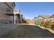 Spacious backyard featuring a well-maintained lawn, a wooden fence, and a deck with staircase leading to the house at 24317 E Powers Ave, Aurora, CO 80016