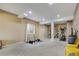Spacious basement area featuring workout equipment, neutral carpet and lighting at 24317 E Powers Ave, Aurora, CO 80016
