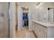Bathroom features double vanity sinks and a walk-in shower, with the closet in view at 24317 E Powers Ave, Aurora, CO 80016