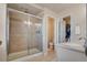 Modern bathroom featuring a glass-enclosed shower, tile flooring and dual vanity at 24317 E Powers Ave, Aurora, CO 80016