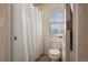 This bathroom features a classic white shower curtain and toilet at 24317 E Powers Ave, Aurora, CO 80016
