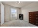 Bright bedroom with plush carpet, dresser, and large window with neighborhood views at 24317 E Powers Ave, Aurora, CO 80016