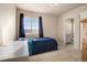 Cozy bedroom features a large window and access to an ensuite bathroom at 24317 E Powers Ave, Aurora, CO 80016
