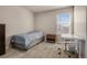 This bedroom offers plush carpet, a desk, and plenty of natural light at 24317 E Powers Ave, Aurora, CO 80016
