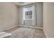 Well-lit bedroom with large window, neutral walls, and carpet at 24317 E Powers Ave, Aurora, CO 80016