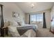 Bright bedroom featuring a large window, neutral color palette, and ample space at 24317 E Powers Ave, Aurora, CO 80016