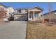 Charming two-story home featuring a covered front porch, landscaped yard, and a two car garage at 24317 E Powers Ave, Aurora, CO 80016