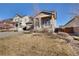 Attractive front yard with a well-maintained lawn, a small tree, and a view of the home's covered front porch at 24317 E Powers Ave, Aurora, CO 80016