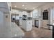 Well-lit kitchen with white cabinets, stainless steel appliances and a center island with granite countertops at 24317 E Powers Ave, Aurora, CO 80016