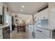 Open concept kitchen and living area with fireplace, dining table, and ample natural light at 24317 E Powers Ave, Aurora, CO 80016