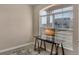 Bright office space featuring a desk facing a large window with blinds at 24317 E Powers Ave, Aurora, CO 80016